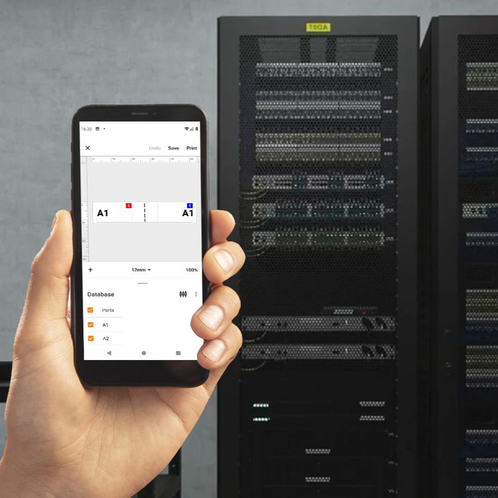 In a dimly lit room, a person holds a smartphone showing the Pro Label Tool interface labeled A1 in front of a large server rack, hinting at an advanced data management and professional labeling setting.