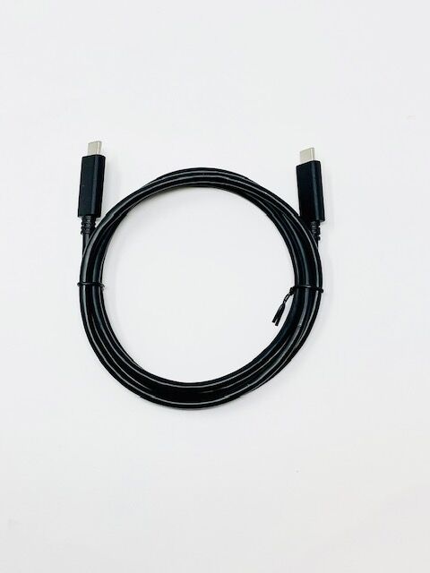 A black USB-C cable coiled in a circle, with connectors visible at both ends, against a plain white background.