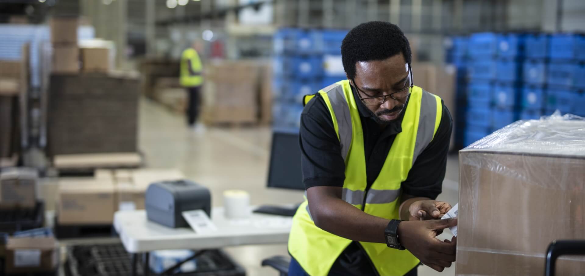 Male Warehouse Associate Labeling Boxes