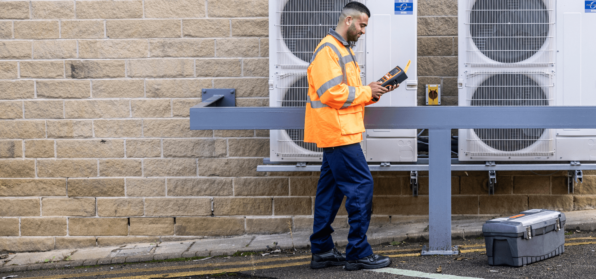 Man walking outside with his label printer in hand