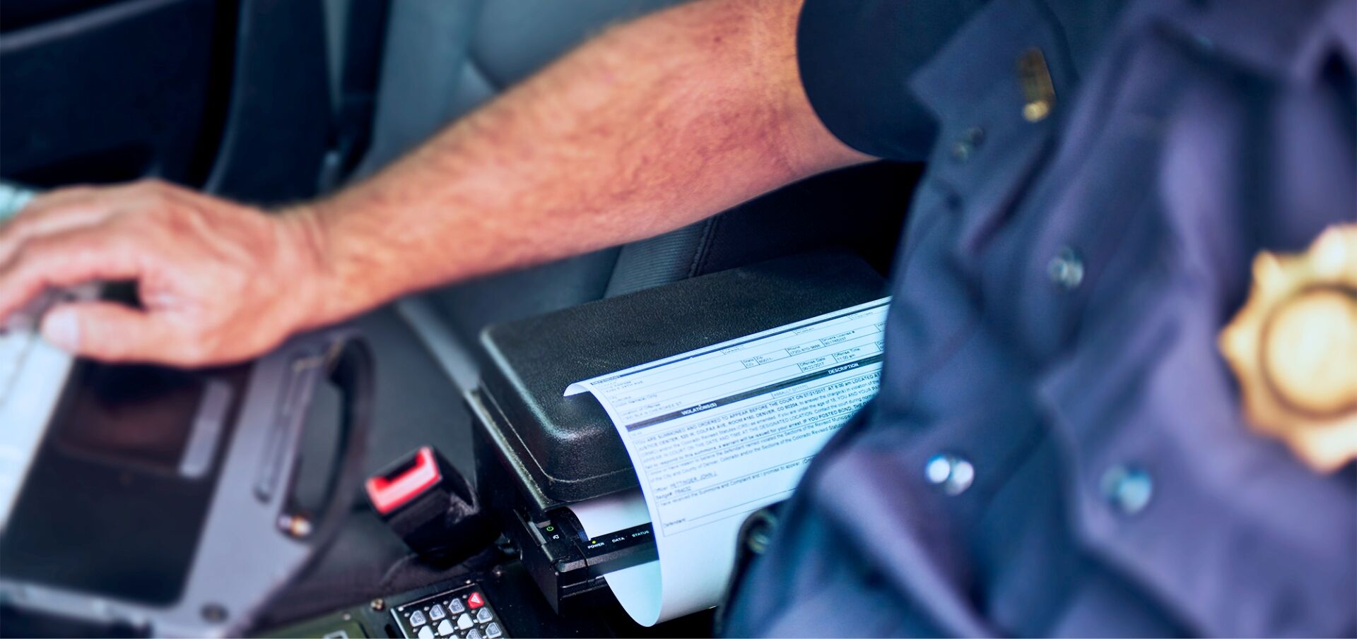 Close up of pocketjet mounted in armrest of police cruiser