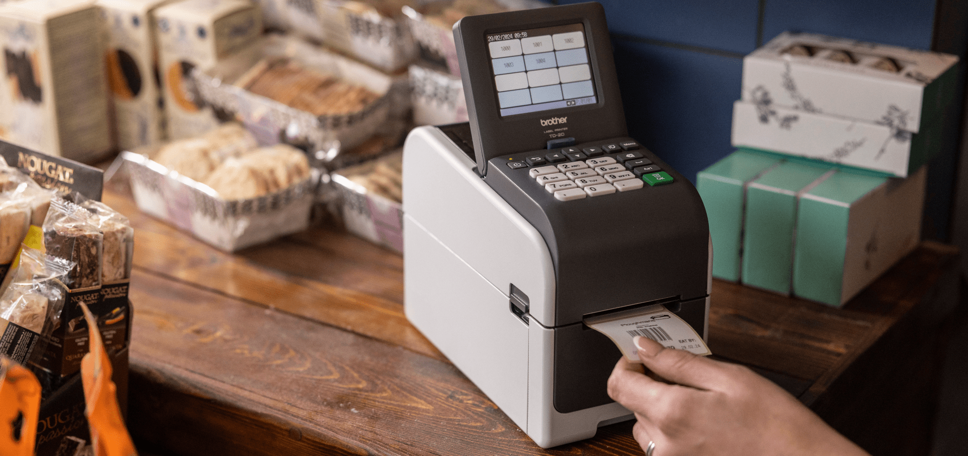 TD 2350DSA Brother printer in a retail coffee shop with woman printing a label