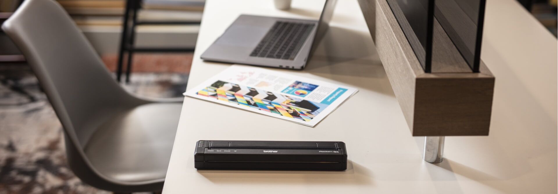 PocketJet 7 Mobile Printer on Desk Next to Computer