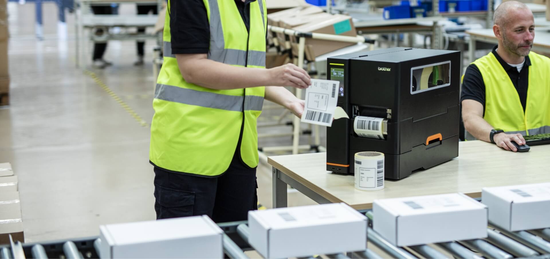 Two Warehouse Employees Using Brother Titan Industrial Printer